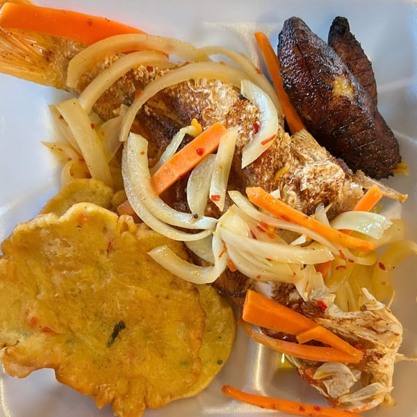 Jamaican escovitch fish with pickled onions and carrots, fried plantains, and a festival dumpling.